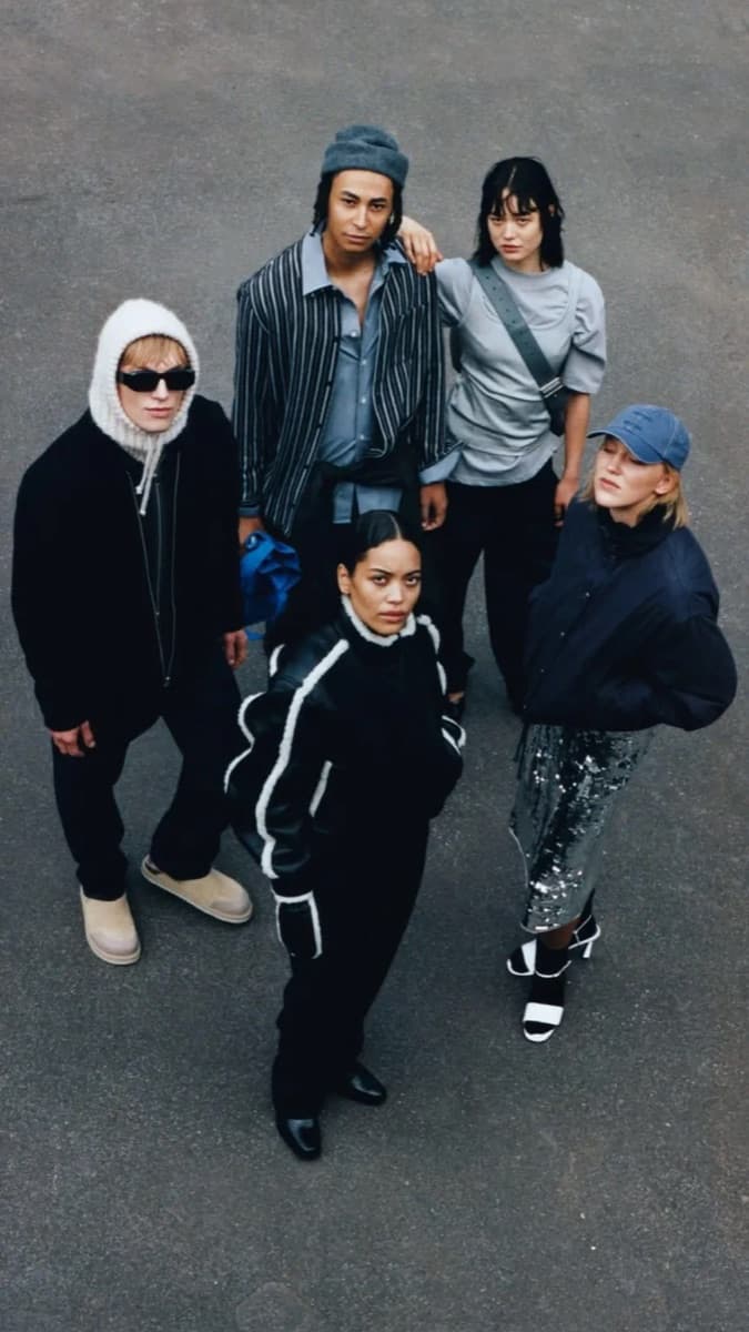 Five friends seen from above in dark jackets, a sequin skirt and a knit balaclava